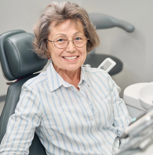 Smiling senior woman seated in a dental chair