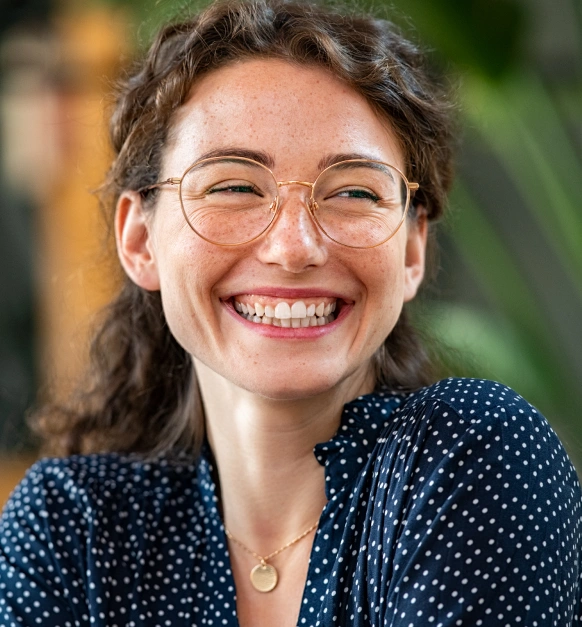 Woman smiling after gummy smile correction treatment results