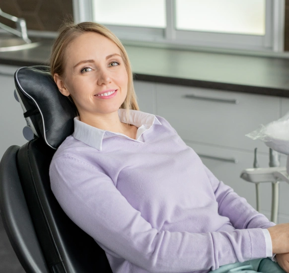 Woman in dental chair receiving periodontal maintenance cleaning treatment