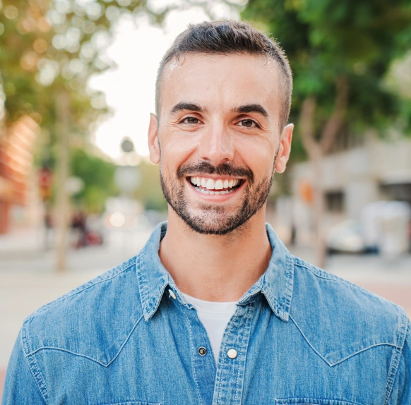 Smiling man outdoors after successful periodontal disease treatment